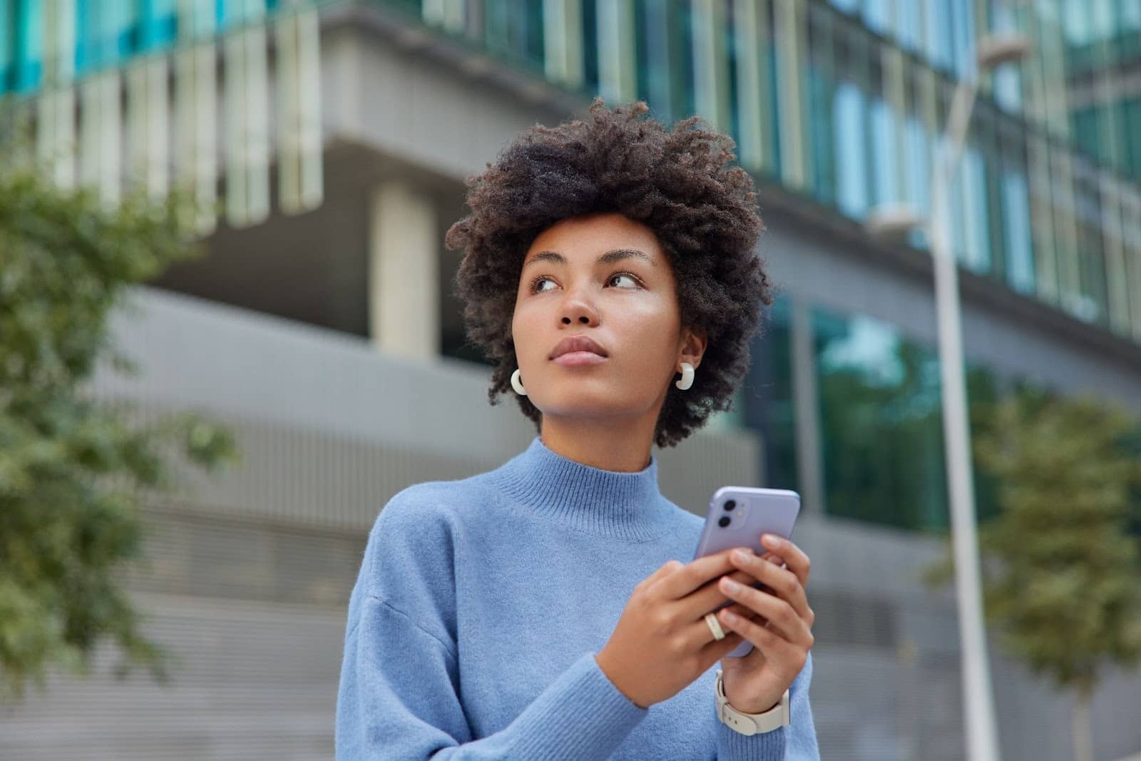 Woman using phone on the street
