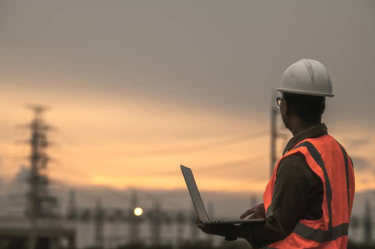 Utilities worker looking at power lines