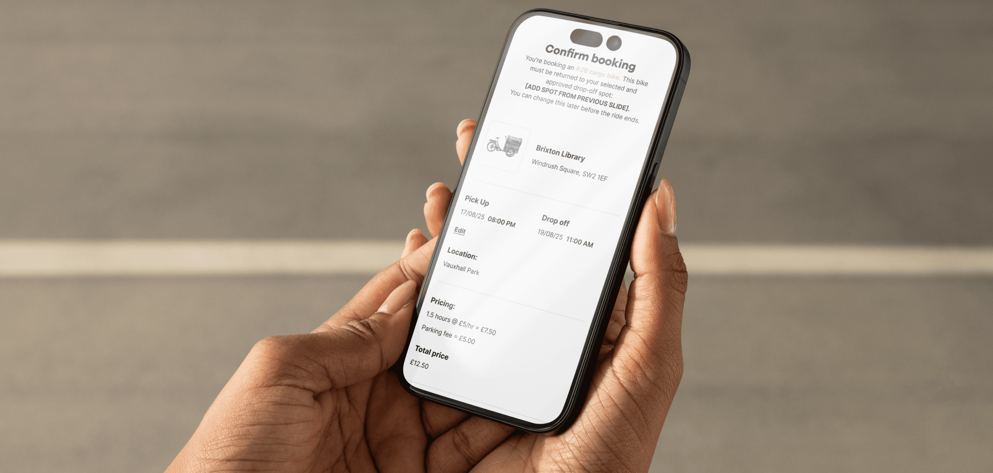 A person holding a phone using the our bike app
