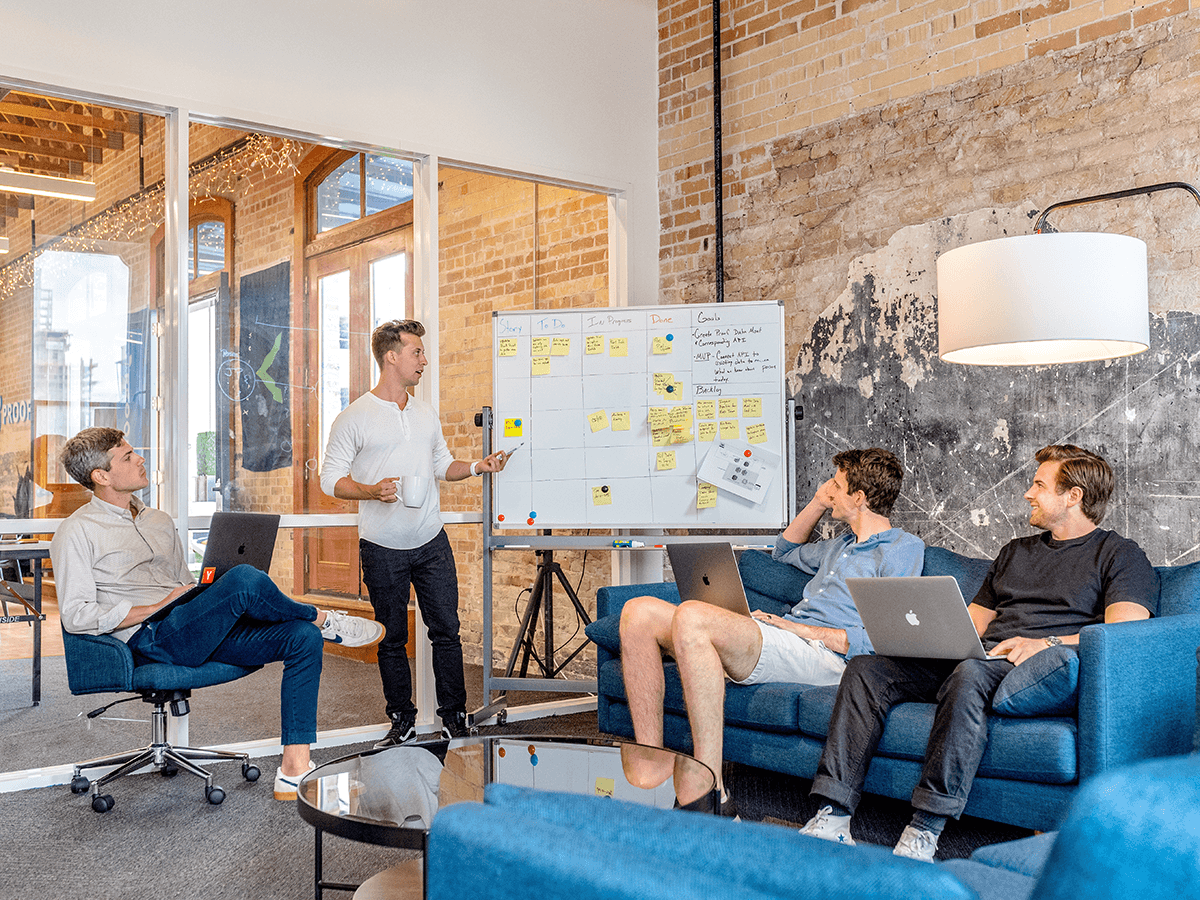 People working around a whiteboard