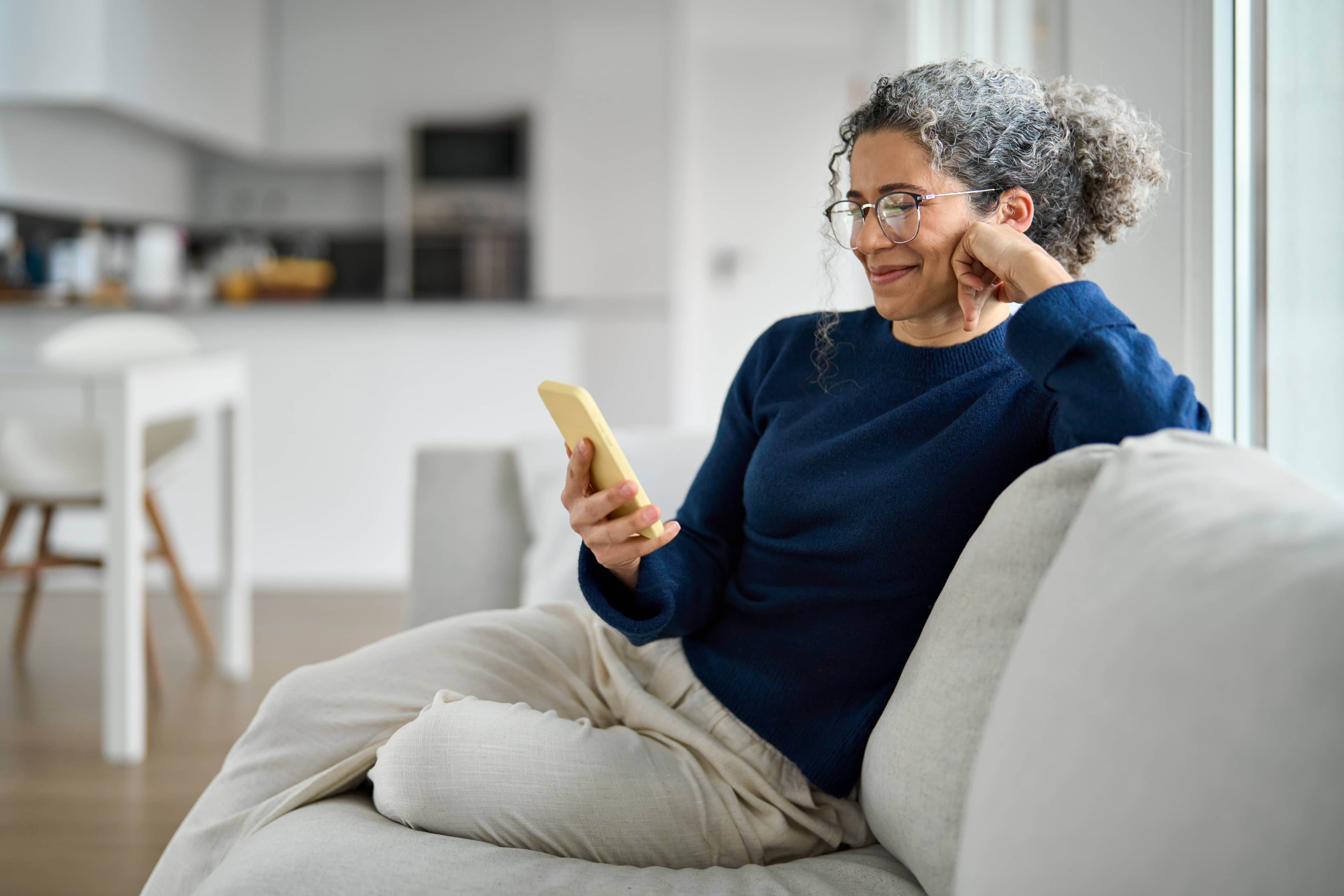 A man on a couch with an orange phone
