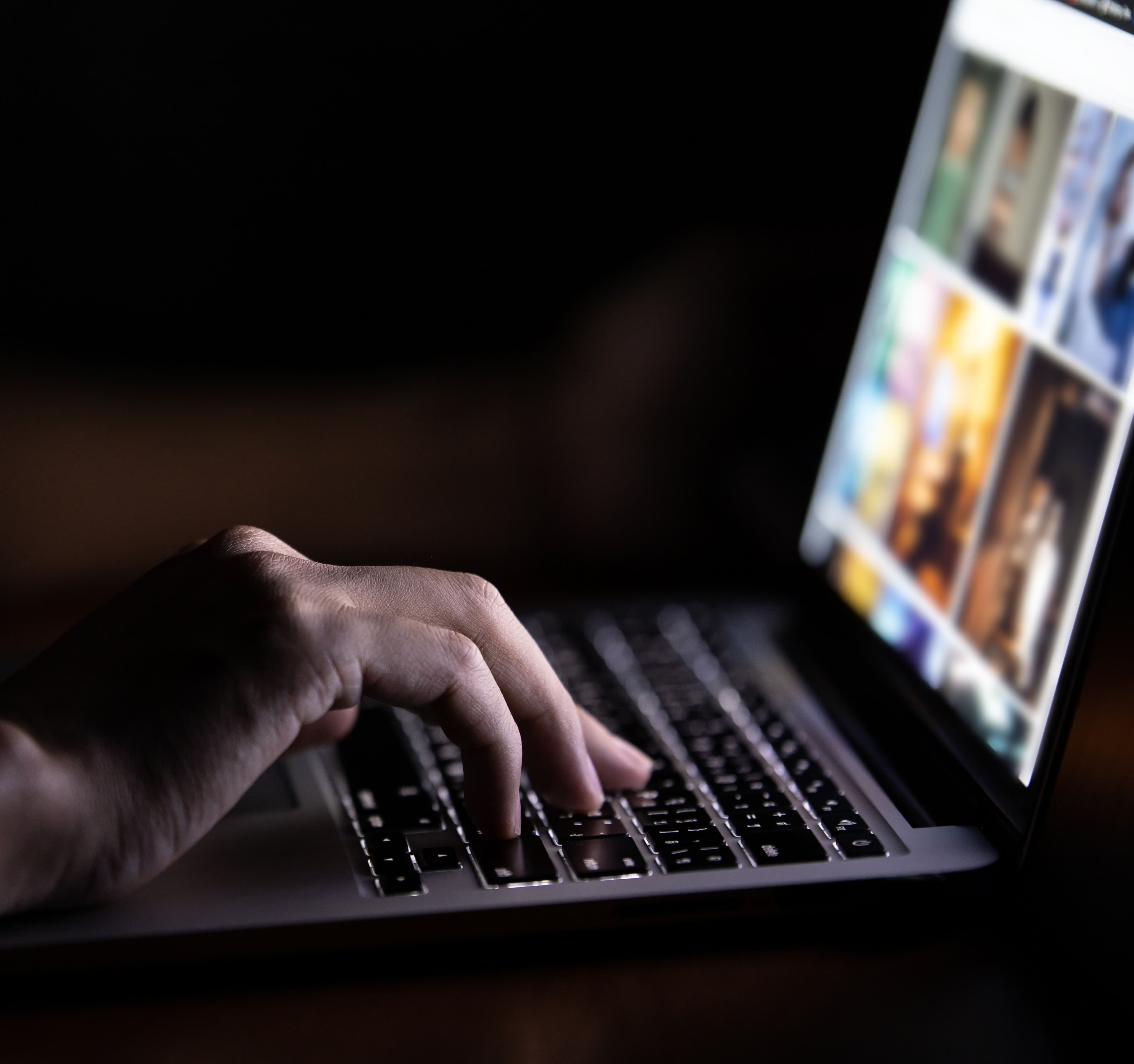 Someone using a laptop at night